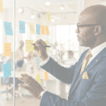 Diomede Sabushimike CEO of Top AI Africa planning AI automation strategy on glass board with sticky notes in modern office - Top AI Africa achievements