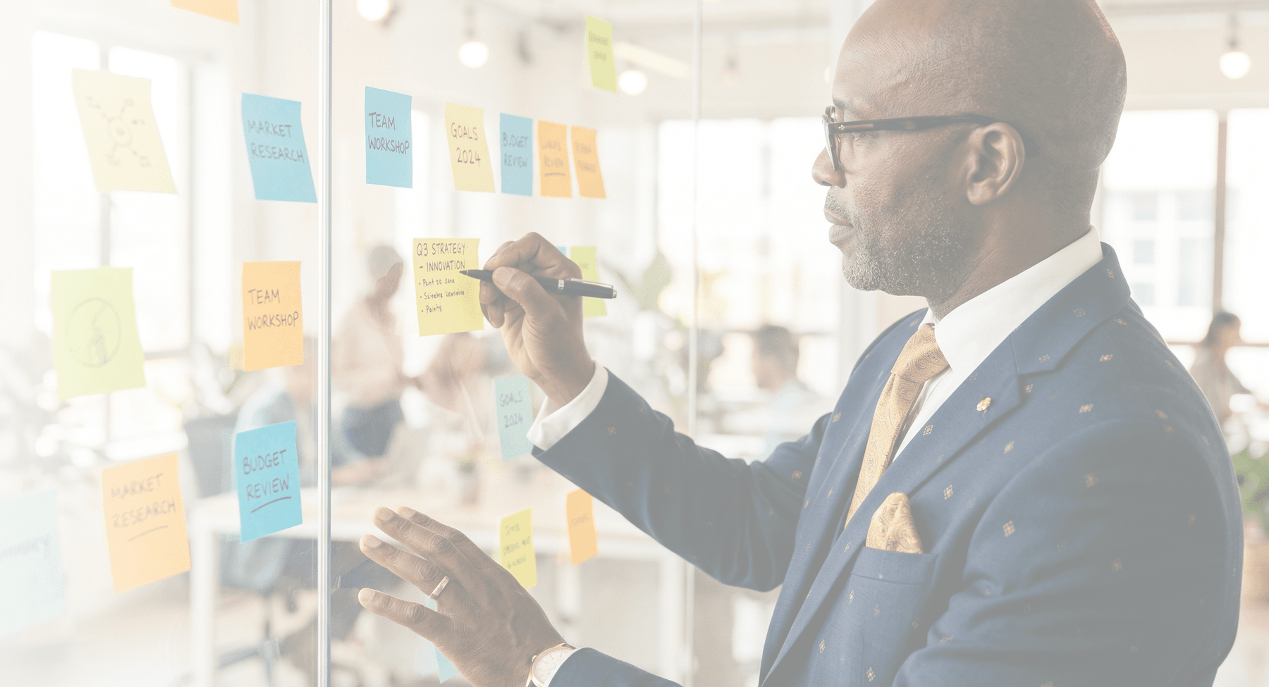 Diomede Sabushimike CEO of Top AI Africa planning AI automation strategy on glass board with sticky notes in modern office - Top AI Africa achievements